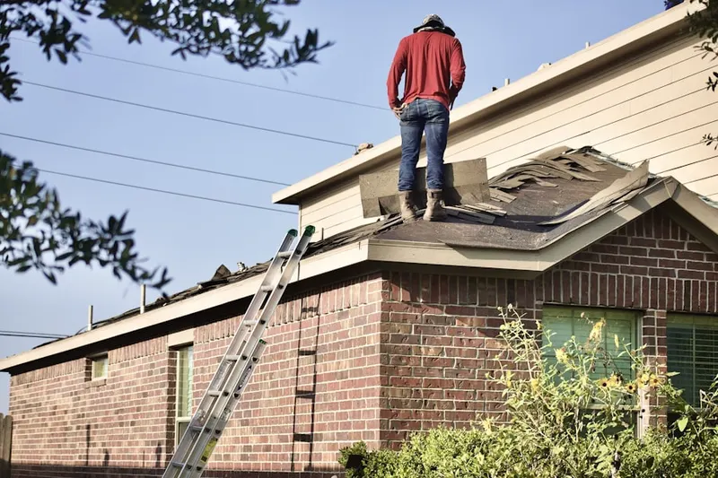 Professional roofer working on a residential roof in Buckingham